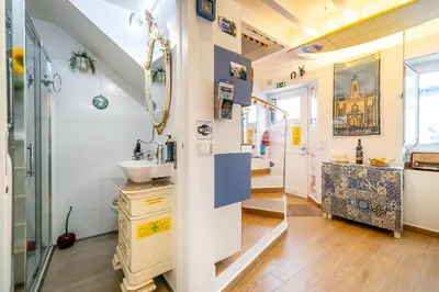 a bathroom with a sink and a shower at Casinha da Ti Babel in Faro