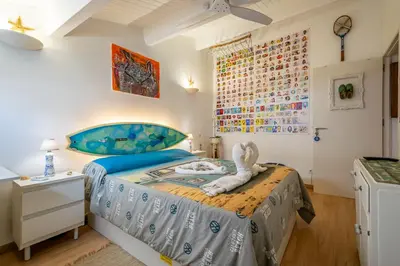 a bedroom with a bed with a stuffed animal on it at Casinha da Ti Babel in Faro