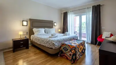 a bedroom with a bed and a large window at Greice Homes-Luxury 2 bed en-suite south facing & Golf view in Quarteira