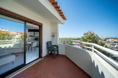a kitchen and living room with a couch and a table at Bellavista Avenida By BeGuest in Albufeira