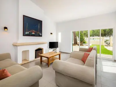 a living room with two couches and a fireplace at Villa Oceano Golf 482 2 Bedrooms Sea Views A Stone's Throw To The Beach in Vale do Lobo
