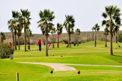 a group of people playing golf on a golf course at Villa Varandas Do Lago 5 Bedroom Villa Private Pool Table Tennis in Vale do Lobo