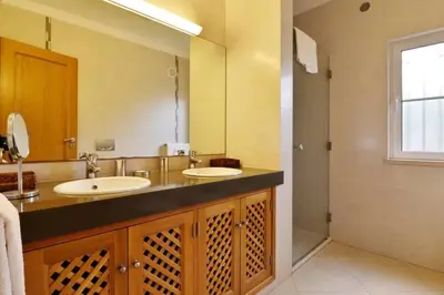 a bathroom with two sinks and a large mirror at Villa Varandas Do Lago 5 Bedroom Villa Private Pool Table Tennis in Vale do Lobo
