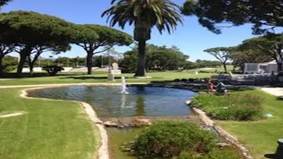 a pond in a park with a fountain at Villa Vale Do Lobo 409 Beautiful 5 Bedrooms Heated Pool Short Walk in Vale do Lobo