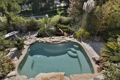 a swimming pool in the middle of a garden at Villa Vale Do Lobo 409 Beautiful 5 Bedrooms Heated Pool Short Walk in Vale do Lobo