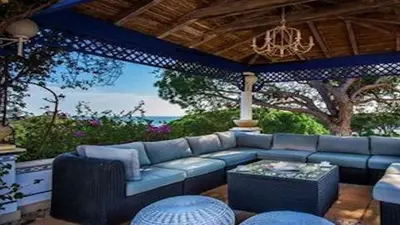 a living room with a blue couch and a table at Villa Vale Do Lobo 409 Beautiful 5 Bedrooms Heated Pool Short Walk in Vale do Lobo