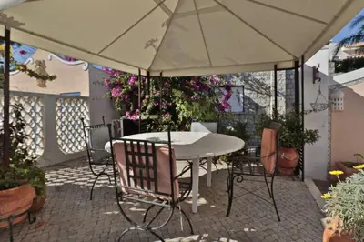 a table and chairs under an umbrella on a patio at Villa Vale Do Lobo 409 Beautiful 5 Bedrooms Heated Pool Short Walk in Vale do Lobo