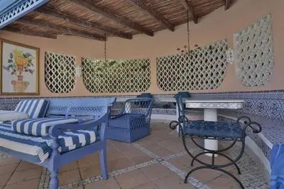 a patio with blue chairs and a table and a bench at Villa Vale Do Lobo 409 Beautiful 5 Bedrooms Heated Pool Short Walk in Vale do Lobo