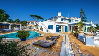 a home with a swimming pool and a house at Villa Vale Do Lobo 409 Beautiful 5 Bedrooms Heated Pool Short Walk in Vale do Lobo