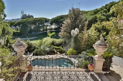 a garden with a fence and a swimming pool at Villa Vale Do Lobo 409 Beautiful 5 Bedrooms Heated Pool Short Walk in Vale do Lobo