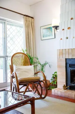a rocking chair in a living room with a fireplace at Villa Quadradinhos 38Q 4 Bedrooms Private Pool Short Walk To The Beach in Vale do Lobo