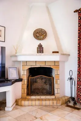 a fireplace with a clock on top of it at Villa Vale Do Lobo 626 3 Bedrooms Private Pool Short Walk To The Praca in Vale do Lobo