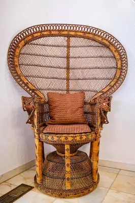 a wicker chair with a pillow in a room at Villa Vale Do Lobo 626 3 Bedrooms Private Pool Short Walk To The Praca in Vale do Lobo