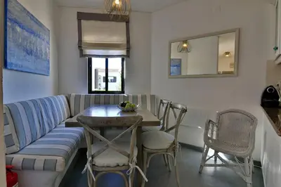 a living room with a couch and a table and chairs at Villa Vale Do Lobo 2 Townhouse 3 Bedroom Close To Amenities And Beach in Vale do Lobo