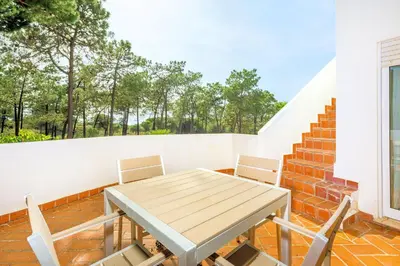 a table and chairs on a balcony with stairs at Charming Vale Do Lobo Villa Private Pool Villa Vale Do Garro 51 in Vale do Lobo