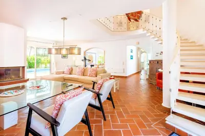 a living room with a table and chairs at Charming Vale Do Lobo Villa Private Pool Villa Vale Do Garro 51 in Vale do Lobo