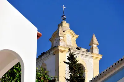 a church steeple with a cross on top of it at Villa Quadradinhos 3Q 4 Bedrooms Private Pool Short Walk To The Praca in Vale do Lobo