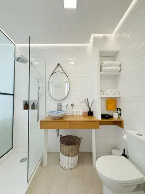 a bathroom with a sink and a toilet and a mirror at Seafront Apartment in Quarteira in Quarteira