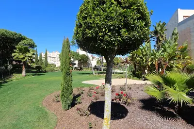 a tree in a park with flowers and trees at Villa Casa da Luz, Palmyra 173 - Clever Details in Vilamoura
