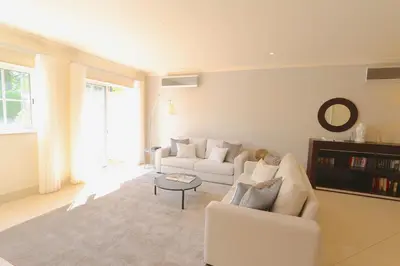 a living room with two white couches and a table at Villa Casa da Luz, Palmyra 173 - Clever Details in Vilamoura