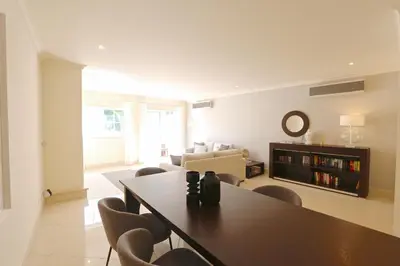 a living room with a dining room table and chairs at Villa Casa da Luz, Palmyra 173 - Clever Details in Vilamoura