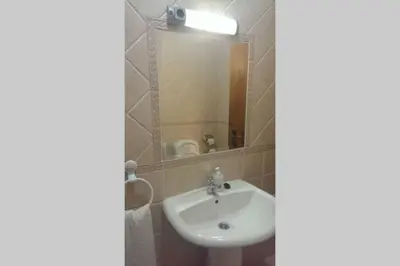 a bathroom with a sink and a mirror at Casa do Avô in Albufeira