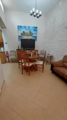 a living room with a table and chairs and a couch at Casa do Avô in Albufeira