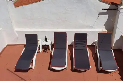 three chairs and a table on a patio at Casa do Avô in Albufeira