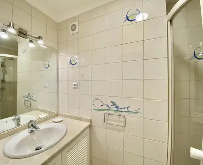 a bathroom with a sink and a mirror at Tália XI - Near the beach - Vilamoura in Vilamoura