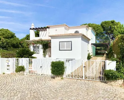 a white house with a white fence at Vila Pereira - Private Pool - Vilamoura in Vilamoura