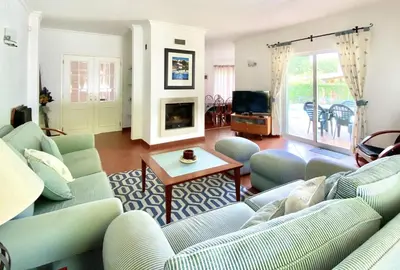a living room with blue couches and a tv at Vila Pereira - Private Pool - Vilamoura in Vilamoura