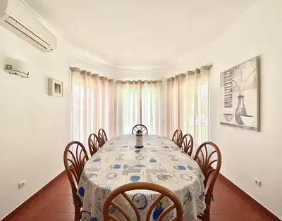 a dining room with a table and chairs at Vila Pereira - Private Pool - Vilamoura in Vilamoura