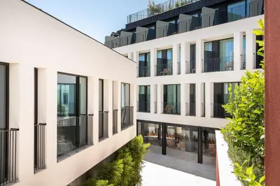 an apartment building with large windows and plants at 3HB Faro in Faro
