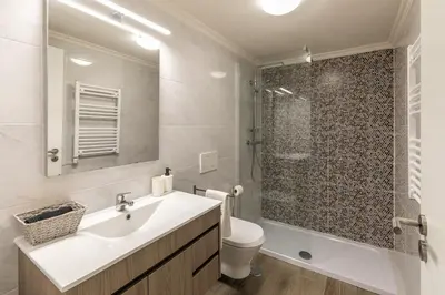 a white bathroom with a sink and a shower at Villa Rodrigues in Boliqueime