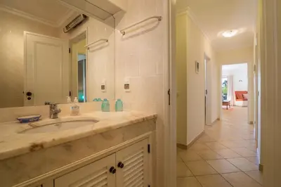 a bathroom with a sink and a mirror at Albufeira Apartment in Albufeira