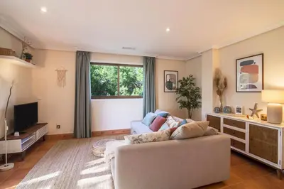 a living room with a couch and a television at Falésia Pine Spot in Albufeira