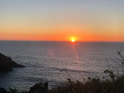 a sunset over the ocean with the sun setting at Pinetops holidays Apartment in Albufeira