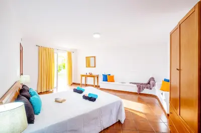 a living room with a bed and a couch at Villa Grace Bay by Algarve Vacation in Guia