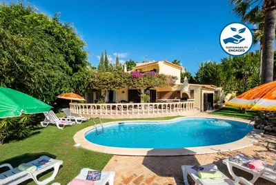 a villa with a swimming pool in front of a house at Villa Bantayan by Algarve Vacation in Albufeira