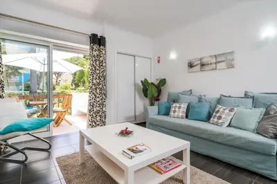 a living room with a couch and a table at Serenity by Intiholidays in Quarteira