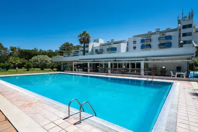 a large swimming pool in front of a building at Serenity by Intiholidays in Quarteira