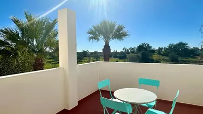 a table and chairs on a balcony with a palm tree at Abby by Check-in Portugal in Albufeira