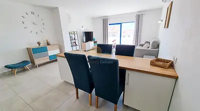a kitchen and living room with a table and chairs at Alta Oura Prime by Sunny Deluxe in Albufeira
