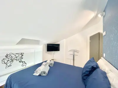 a bedroom with a blue bed and a television at Mira Marina - Vilamoura in Vilamoura