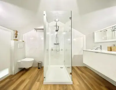 a white bathroom with a shower and a toilet at Mira Marina - Vilamoura in Vilamoura