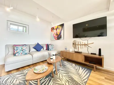 a living room with a couch and a tv at Mira Marina - Vilamoura in Vilamoura