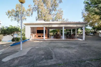 a pavilion with tables and chairs in a parking lot at Bosque São José Af in Albufeira