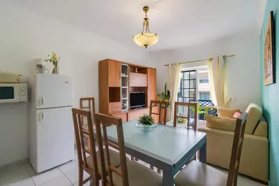 a kitchen and dining room with a table and a refrigerator at Bosque São José Ag in Olhos de Água