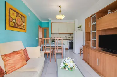 a living room with a couch and a tv at Bosque São José Ag in Olhos de Água