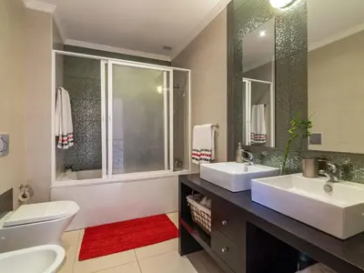 a bathroom with two sinks and a toilet and a tub at Holiday Home Bela Vitta by Interhome in Ferreiras